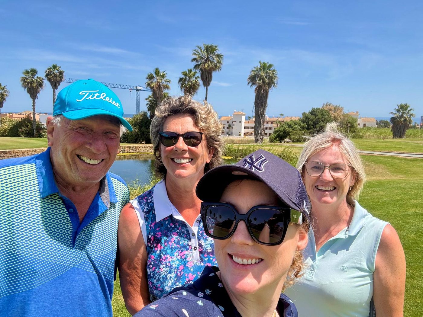 Society fourball with palms and sea behind