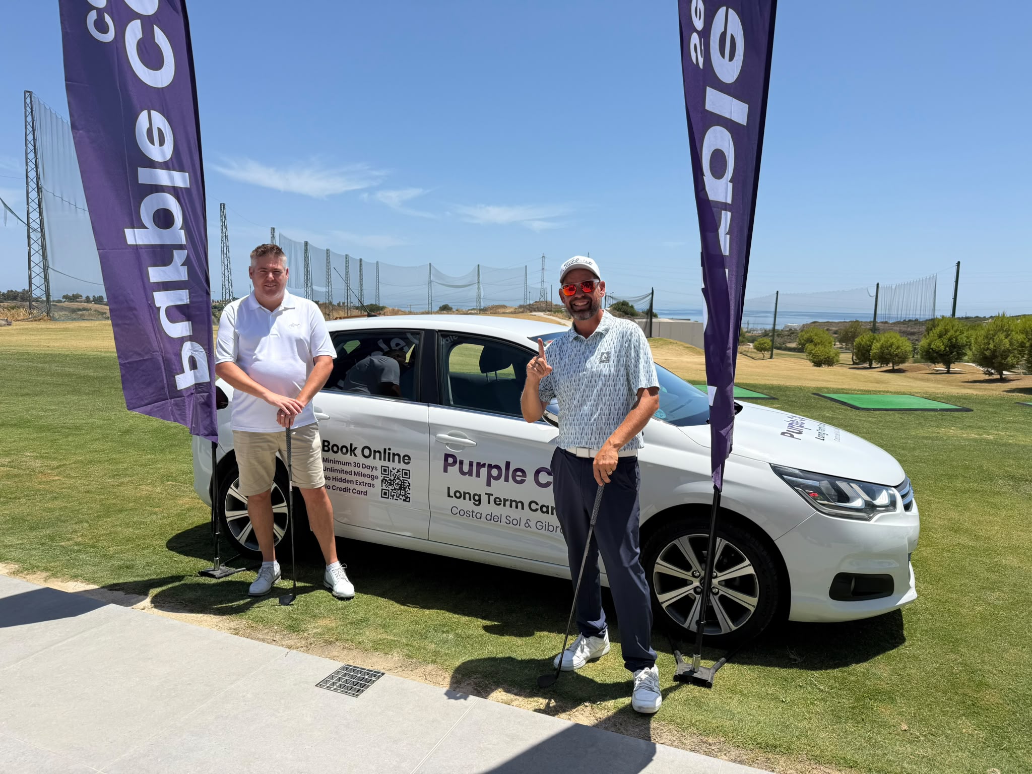 Two golfers by the Purple Cars car at Azata Golf